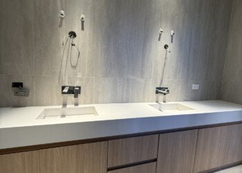 Mueble de baño a medida con cajoneras, puertas batientes y grifería embutida a la pared
